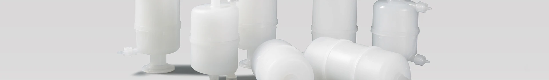 Various capsule filter cartridge on a gray background