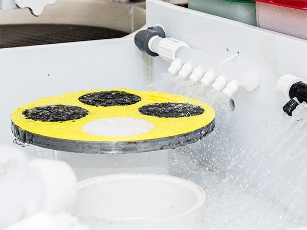 The wafer is being polished using grinding slurry
