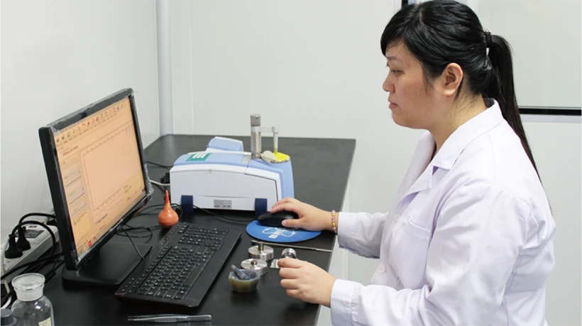 Researchers are checking the product leachate data displayed on the computer in the laboratory