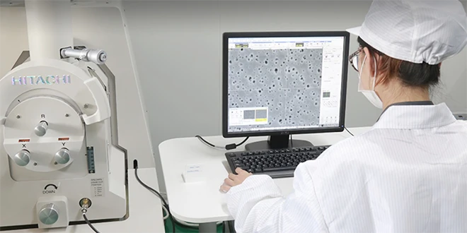 Researcher observing filter core performance on the computer